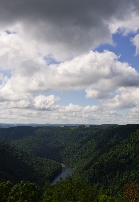 A mountain top view of a river flowing through a valley