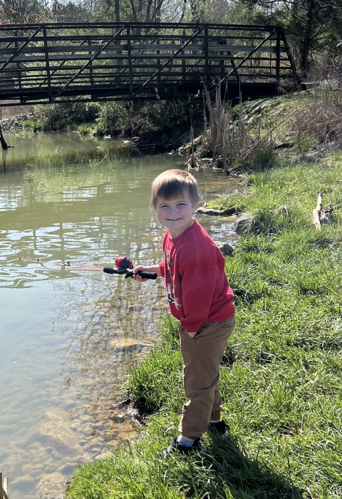 Kid fishing in stream