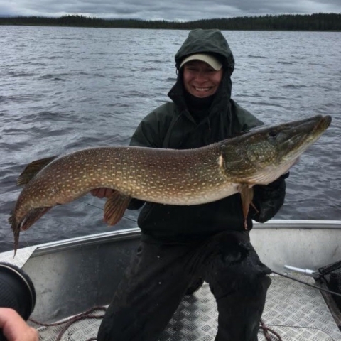 Image of Zachary Eisenhauer holding a fish on a boat.