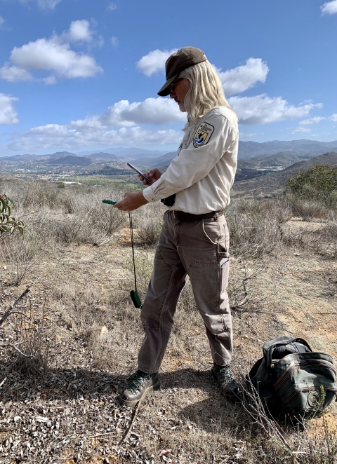 Emeritus biologist records weather in a shrubby, dry landscape.