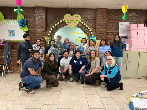16 people pose together