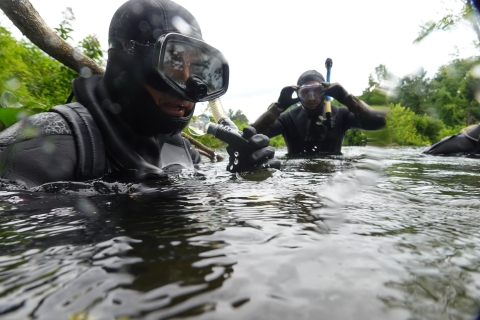 Two snorkelers standing in a river