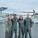 four pilot biologist in front of two planes