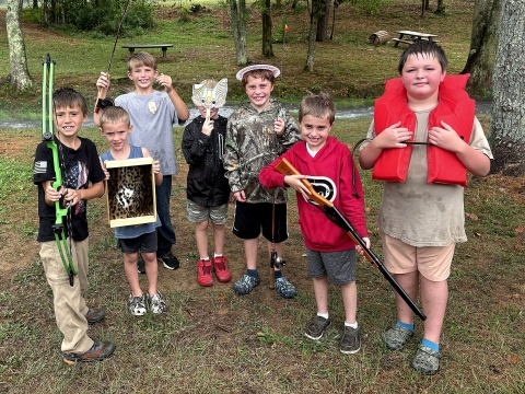 Children holding things they did at Wilderness Day Camp