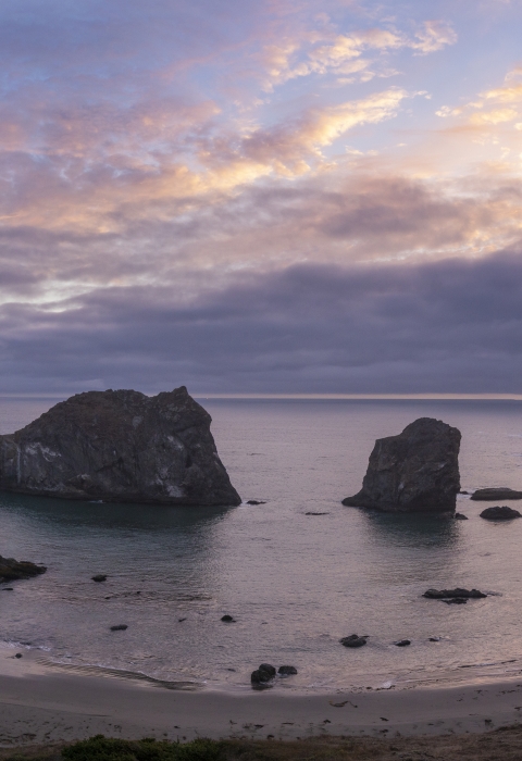 Sunset over a group of offshore rocks