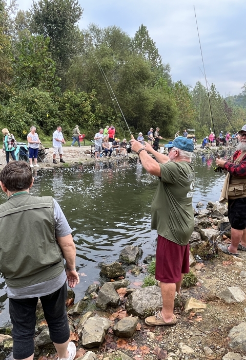 Fishermen on the edge of stream