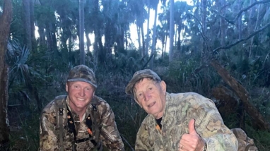 Barry Owens kneels with his grandson Daniel Verdin who harvested the 8 point buck shown in the photo.