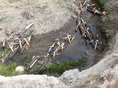 A stream from above filled with bundles of logs