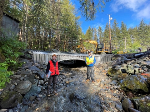 U.S. Fish and Wildlife Service and Natural Resource Conservation Service staff standing in front of a culvert replacement project on Hendrickson Creek on Douglas Island, near Juneau, Alaska conducting construction monitoring and surveys.