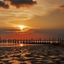 Remains of old pier at sunset