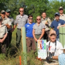 Friends of the Refuge Headwaters holding tree tubes outside.