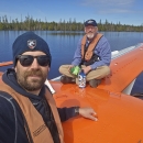 two pilot biologists sitting on top of a seaplane