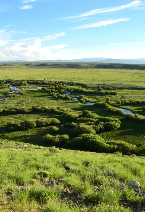 Distant view of a river winding through prairie.