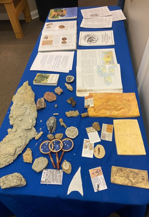 Table with fossils, books, and magnifying glasses