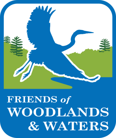 Logo for the Friends of Woodlands and Waters- shows silhouette of a great blue heron over woods and waters.