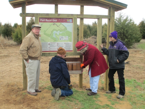 Volunteers installing a Kiosk at Port Royal Unit