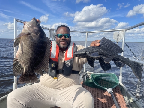 Fish Biologist Cedric Doolittle displaying non-native catch during an early detection survey