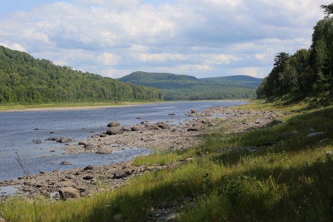 a landscape of a river and mountains