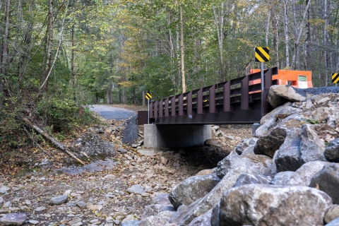 A bridge crosses a dry creek bed. 
