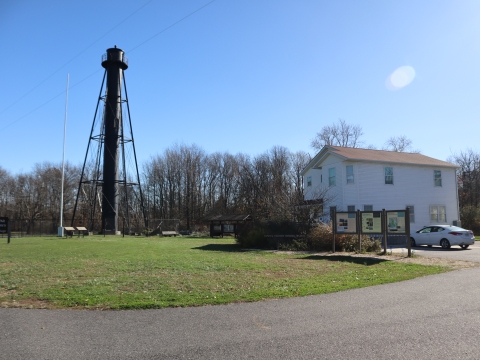 Supawna Meadows Lighthouse. The massive iron structure stands on the front lawn of our Visitor Center on a clear blue day. 