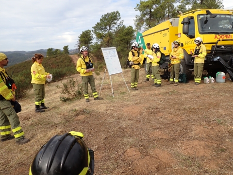 firefighters in circle around whiteboard