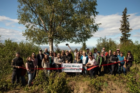 Partners at ribbon cutting at the conservation property celebrating the official creation of Potter Marsh Watershed Park. Photo by Great Land Trust
