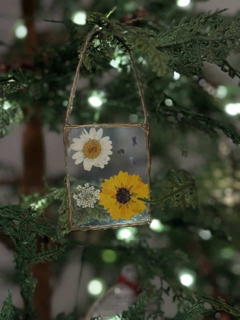 Homemade pressed flower ornament on tree