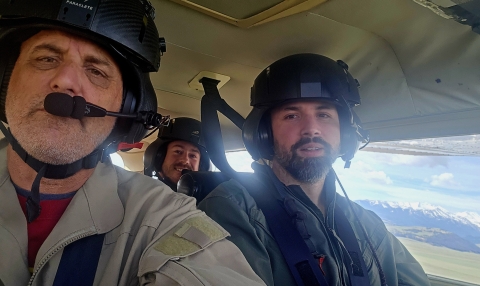 Aerial survey crew Zach Lyall (front right), Jeff Drahota (front left), and Trey McClinton in a plane