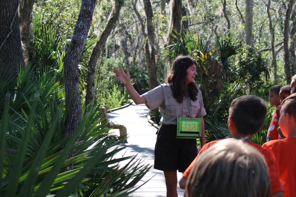 A U.S. Fish and Wildlife Service ranger leads a group of elementary school children on an outdoor experience
