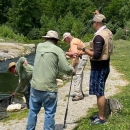 A group of men fly fishing