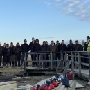 a group of people stand on a boardwalk during a construction project