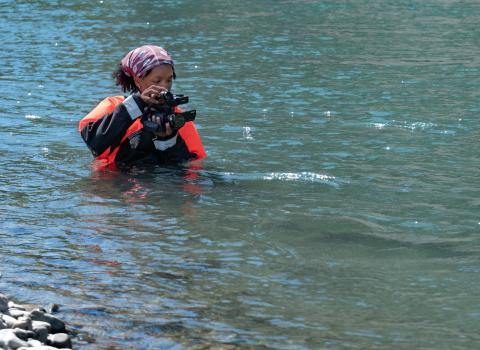USFWS intern, Typhanie Shepherd, filming on the Elwha River in her drysuit.