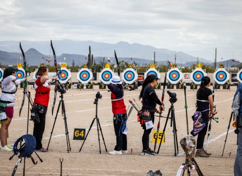 Five archers line up to shoot targets at the Arizona Cup. 
