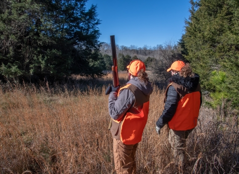 Two women hunting in fall field