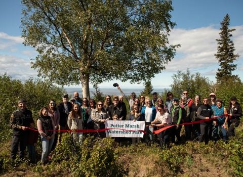 Partners at ribbon cutting at the conservation property celebrating the official creation of Potter Marsh Watershed Park. Photo by Great Land Trust 