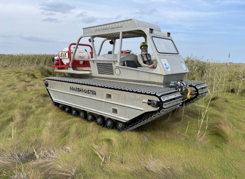 Coastal Program biologist operating a marsh master in the Little Creek Wildlife Area near Port Mahon Delaware
